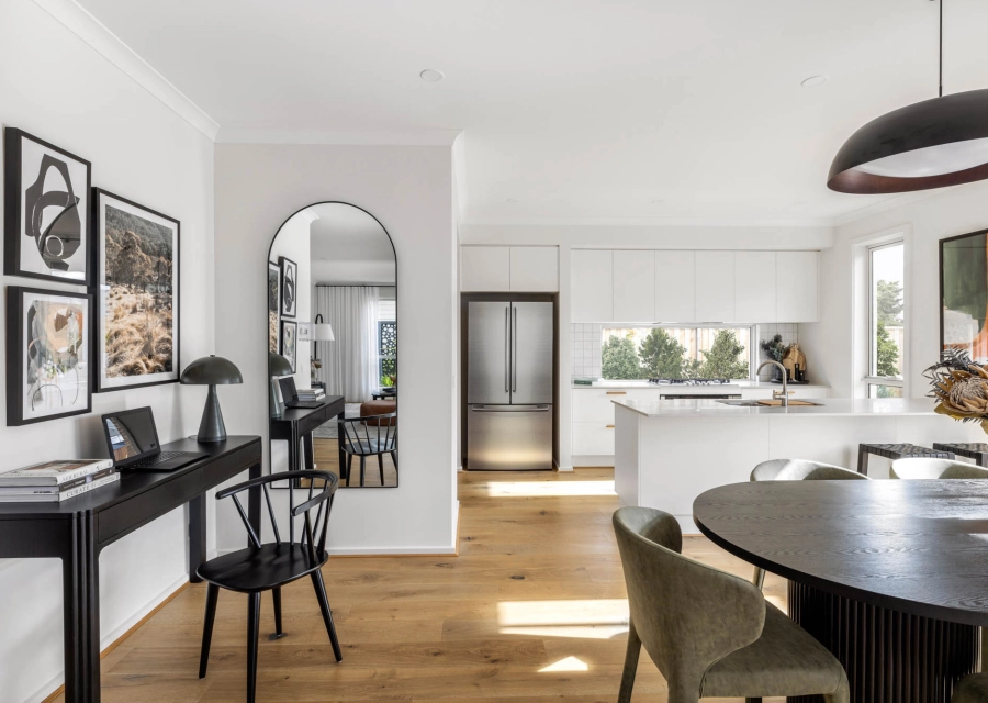 Interior image of a modern living area with a study space and an open-concept kitchen facing the dinning area as part of Simonds Nowra 26 home design.