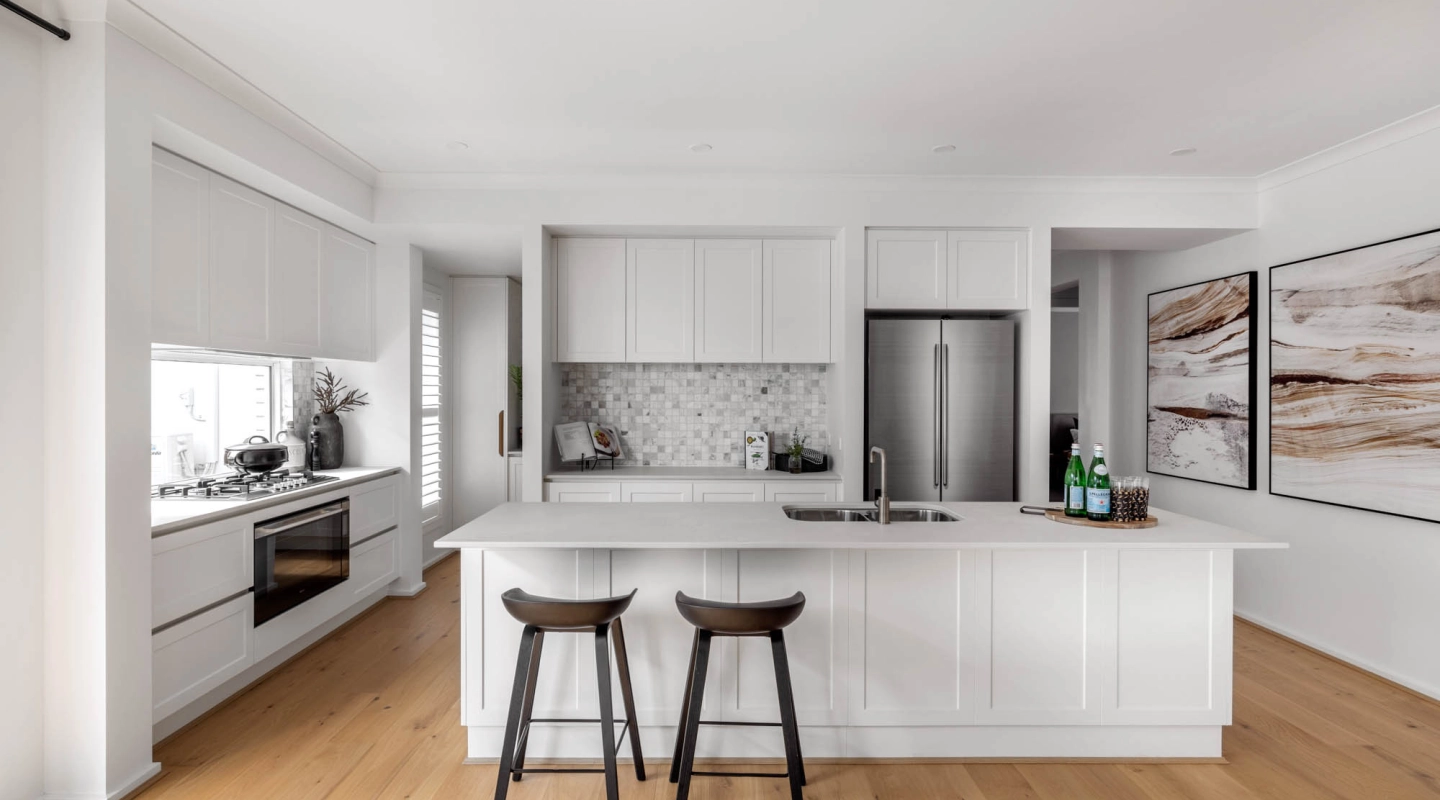 An image of an open living kitchen with wooden flooring that blends modern living as part of Simonds Riverway 26 home design.